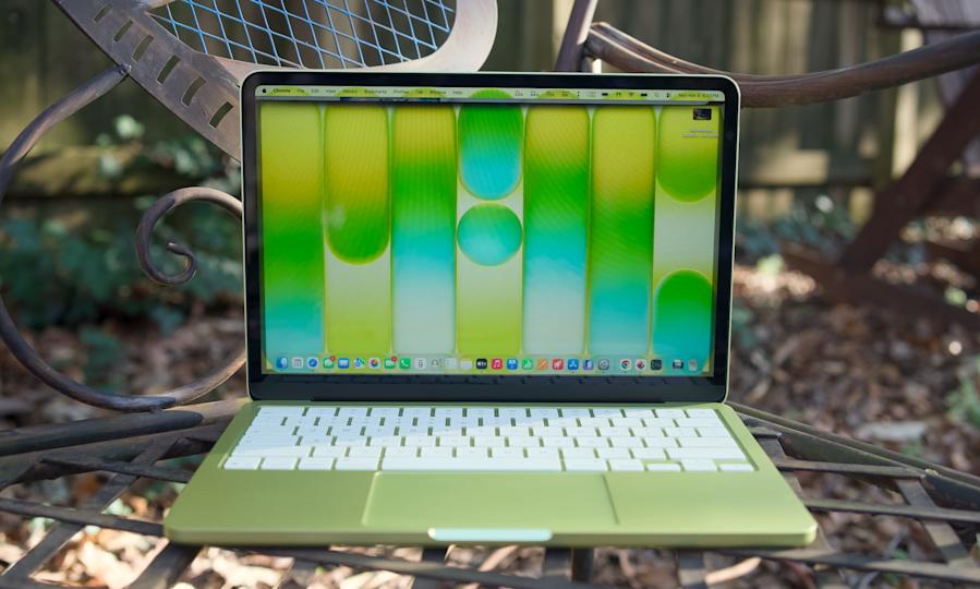 جهاز MacBook Neo بالحمضيات على طاولة بالخارج.